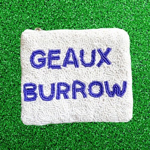 May include: White beaded pouch with a zipper closure. The pouch has the words "GEAUX BURROW" in purple beads.