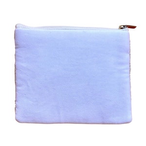 May include: A white canvas zippered pouch with a white zipper.