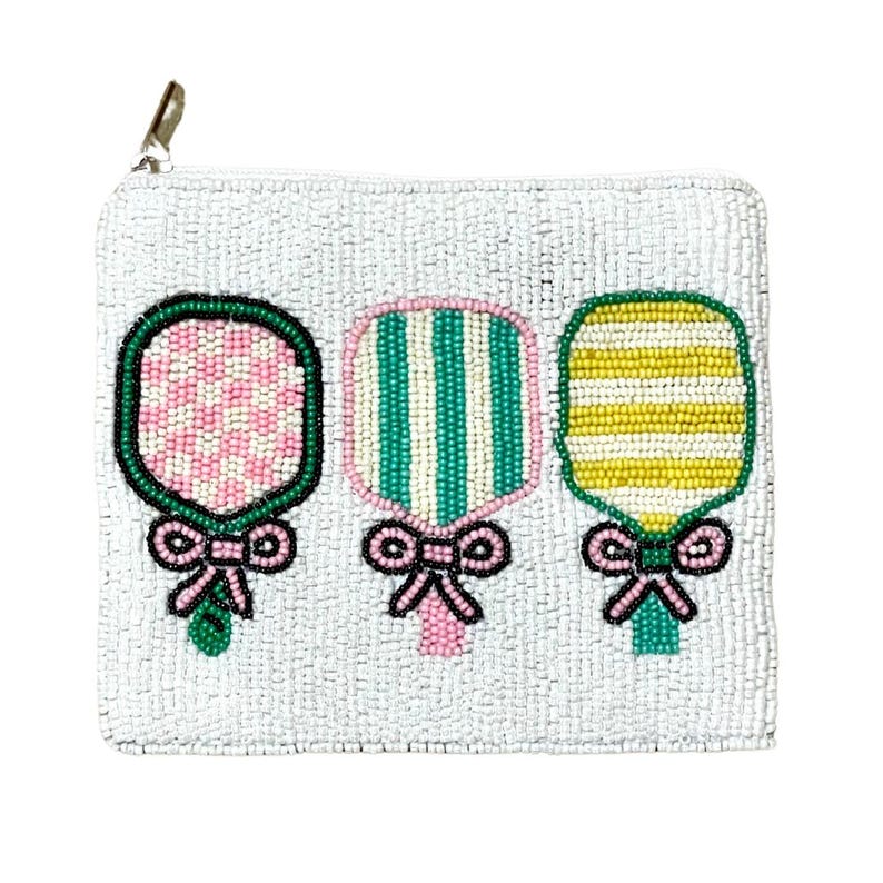 May include: A white beaded zippered pouch with three beaded paddle designs. The paddles are pink, green, and yellow with white stripes. Each paddle has a pink bow.