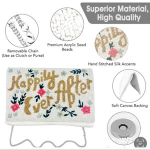 May include: White beaded clutch with a gold "Happily Ever After" inscription and floral accents. The clutch has a removable chain strap and a magnetic closure.
