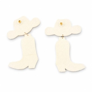 May include: A pair of off-white earrings featuring a cowboy hat top piece connected by a small metal jump ring to a cowboy boot bottom piece. The back of each earring shows a gold-toned metal post backing secured to the center of the hat.