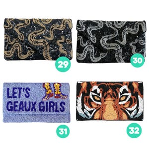 May include: Four rectangular beaded clutch bags. Number 29 is black with gold snakes. Number 30 is black with silver snakes. Number 31 is light blue with the text LET'S GEAUX GIRLS and cowboy boots. Number 32 features a tiger face design.