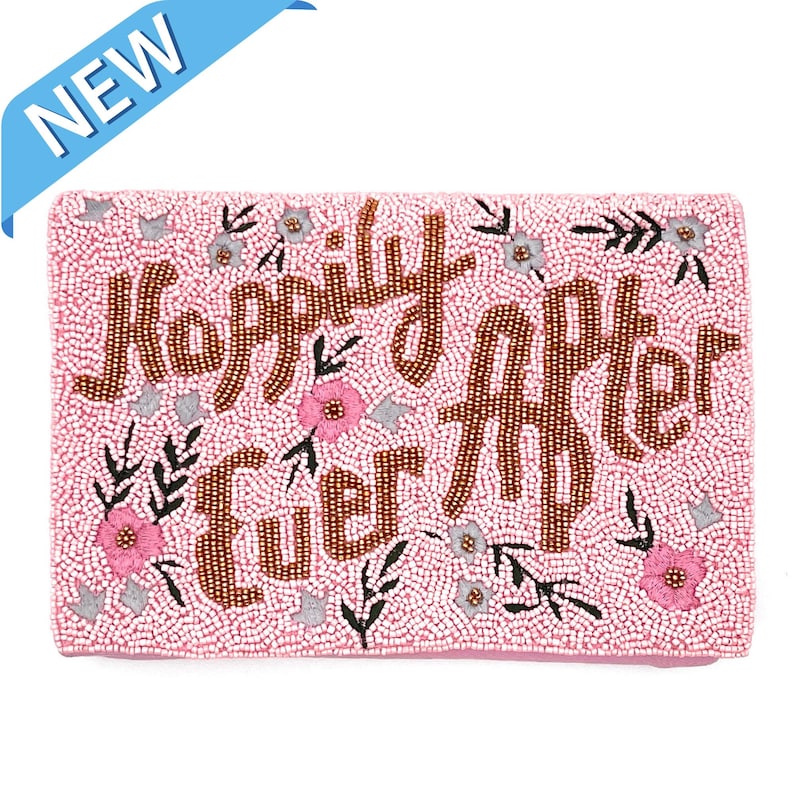 May include: A pink beaded clutch with the words "Happily Ever After" in gold beads. The clutch is decorated with small pink and white flowers and leaves.