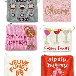 May include: A collection of beaded coin purses in various colors, each featuring a different cocktail-themed design. The purses display phrases like "Espresso Funds," "Cheers!," and "Sip Sip Hooray," along with cocktail illustrations. Each purse has a zipper closure.