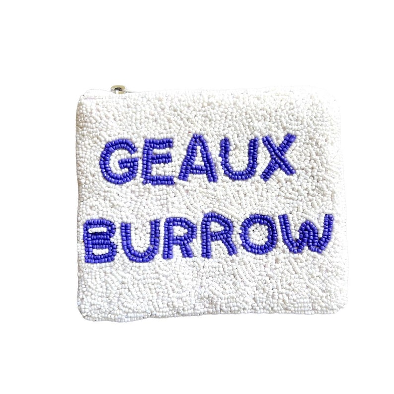 May include: White beaded pouch with a zipper closure. The pouch has the words "GEAUX BURROW" beaded in purple.