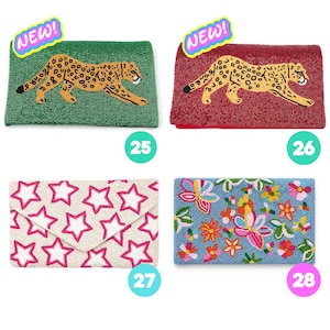 May include: Four rectangular beaded clutch bags. Number 25 is green with a leopard, 26 is red with a leopard, 27 is cream with pink stars, and 28 is blue with a multi-colored floral pattern. Each bag features a 'NEW!' sticker in the corner.