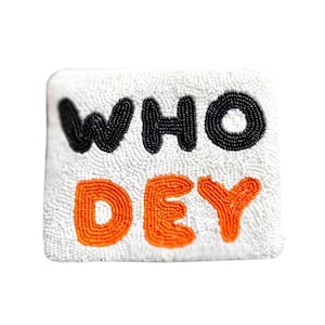 May include: White beaded clutch with the words "WHO DEY" in black and orange beads.