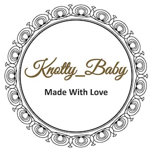 May include: Black and white circular frame with a decorative border. The text "Knotty_Baby Made With Love" is written in brown inside the frame.