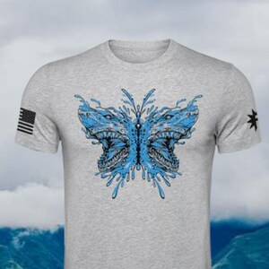 May include: A gray t-shirt with a blue and black graphic of a butterfly with shark heads. The butterfly is surrounded by water droplets.