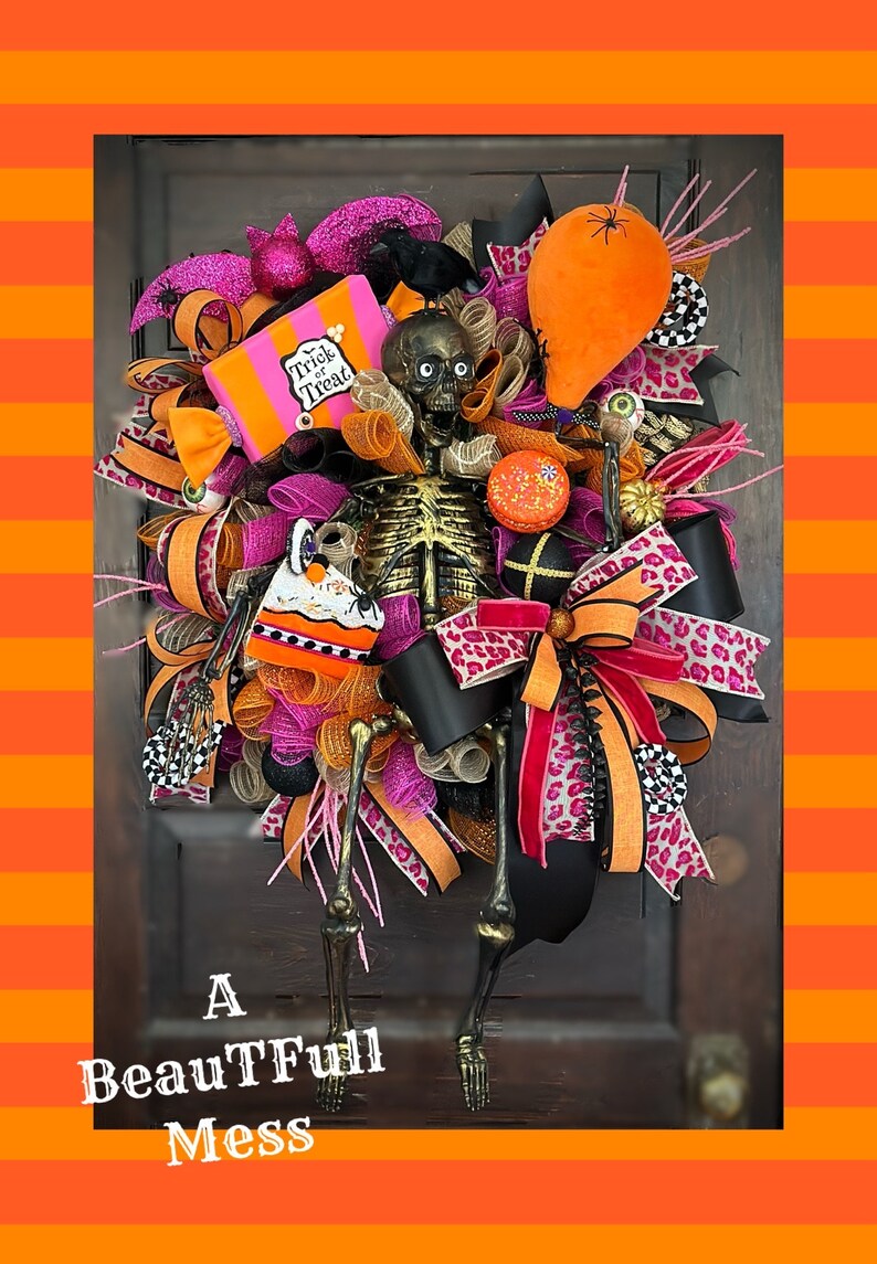 May include: A Halloween wreath with a skeleton, a black crow, a pink and orange "Trick or Treat" box, a pink and orange bow, and a black and orange leopard print ribbon.