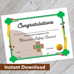 May include: A printable certificate for the Brownie Safety Award. The certificate has a green border with a gold and rainbow design. It says "Congratulations" and "for successful completion of the Brownie Safety Award". There are spaces for the leader's name, troop number, and date.