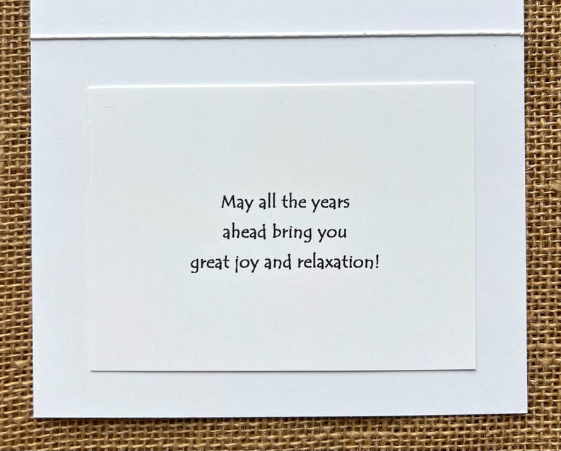May include: A white greeting card with a white border and a white interior. The card's interior has the text: "May all the years ahead bring you great joy and relaxation!"