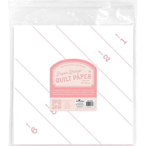 May include: A package of Paper Strings Quilt Paper, 10"x10" sheets, 42 pieces. The paper is white with pink diagonal lines and a pink label with text. The package is sealed in clear plastic.