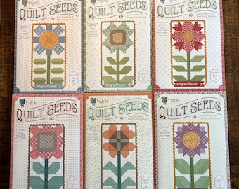 May include: Six quilt pattern booklets titled "Quilt Seeds" featuring floral designs. Each booklet showcases a different patchwork flower, with the text "Stitch Your Garden Together" and "Collect All 6". The booklets are in various colors.