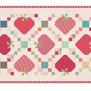 May include: A rectangular quilt featuring a repeating pattern of red strawberries with green stems and leaves. The strawberries are set against a cream background with colorful square accents and a scalloped pink border. The quilt has a patchwork design.
