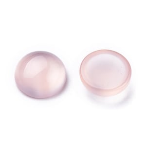 May include: Two round, polished, pale pink gemstones. One is a full cabochon, the other is a cabochon with a flat bottom and a slightly concave top. The stones are smooth and translucent, with a soft, milky appearance.