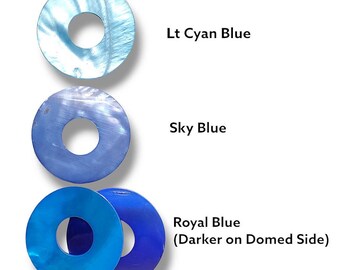 May include: Three circular, iridescent blue objects with a hole in the center, arranged vertically. The top one is Lt Cyan Blue, the middle Sky Blue, and the bottom Royal Blue, with text labels for each color.