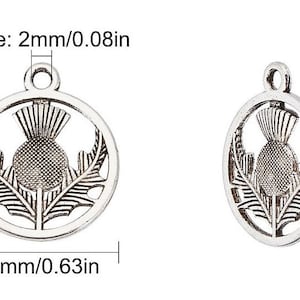 May include: Two silver-colored thistle charms. One is round, 0.75 inches tall and 0.63 inches wide, with a 0.08-inch hole. The other is oval, 0.75 inches tall and 0.63 inches wide, with a 0.04-inch hole. Both feature a thistle design.