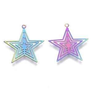May include: Two iridescent star-shaped pendants. Each star has a layered design with a small loop at the top for hanging. The colors shift from green to blue to purple, creating a rainbow effect. These are suitable for jewelry making.