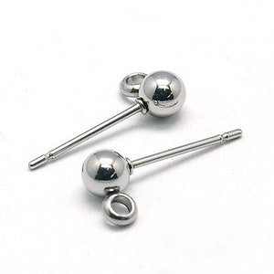 May include: Two silver-colored stud earrings with a spherical design and a post for piercing. Each earring has a small loop attached below the sphere. The earrings are displayed on a white background.