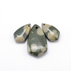 May include: Three teardrop-shaped pendants with a hole at the top for stringing. The pendants have a mottled pattern of green, beige, and white. The pendants are likely made of stone or a similar material.