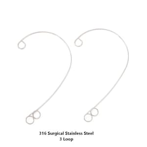 May include: Two surgical stainless steel wire loops. Each loop has a curved design with a small loop at the top and three small loops at the bottom. The text "316 Surgical Stainless Steel 3 Loop" is at the bottom.