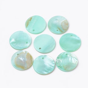 May include: Eight round, light teal-colored shell beads with a pearlescent sheen. Each bead has a small hole near the top for stringing. Some beads have subtle tan and cream-colored markings.