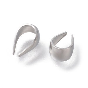 May include: Two silver-colored, U-shaped metal jewelry findings. The findings have a smooth, matte finish and a curved design. They are likely used for jewelry making or crafting projects.