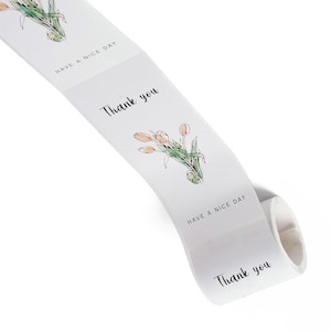 May include: A roll of white stickers with the phrases "Thank you" and "Have a nice day" printed in black. Each sticker features a watercolor illustration of orange tulips with green stems and leaves.