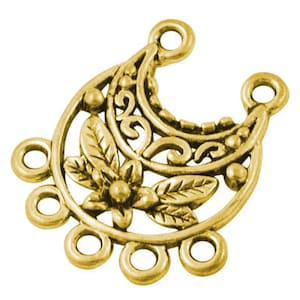 May include: A gold-colored filigree charm with a floral and leaf design. The charm has multiple loops for attaching to other jewelry components. The design includes a flower and leaves in the center, with decorative swirls and dots.