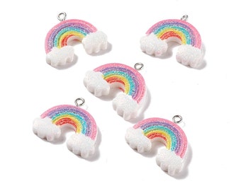 May include: Five rainbow charms with glitter accents and white cloud details. Each charm features a rainbow arch with colors including pink, yellow, green, and blue. The charms have a silver loop for attaching to jewelry or crafts.