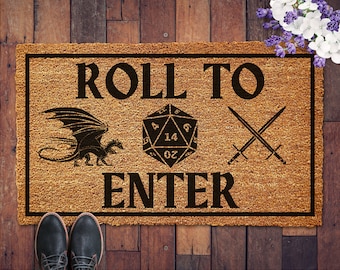 May include: A brown coir doormat with the text "Roll to Enter" in black. The doormat also features a black dragon, a black and white 20-sided die, and two crossed swords.