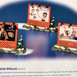 May include: A set of three miniature roadside billboards with vintage advertisements. The billboards are made of wood and have a red lattice design. The advertisements feature images of people and products from the past. The billboards are set on a snowy base with small evergreen trees.