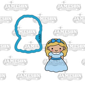 May include: A blue cookie cutter shaped like a girl with blonde hair and a blue bow, alongside a matching cookie. The word "CLARA" is printed on the side of the cutter. The cookie cutter is from the Jameson Cookie Company.