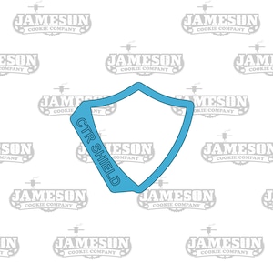 Puede incluir: Un cortador de galletas de plástico azul claro en forma de escudo con las palabras "CTR SHIELD" escritas en diagonal en la parte superior.