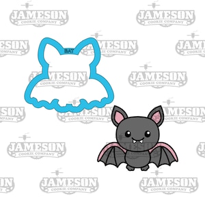 May include: Two bat-themed cookie cutters. One is a blue outline of a bat shape with the word "BAT" in the center. The other is a cartoon bat with gray fur, pink wings, and a smiling face.