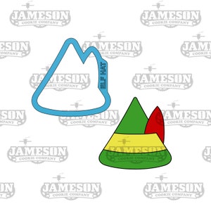 May include: A blue elf hat cookie cutter with the words "ELF HAT" written on it.  There is a green, yellow, and red elf hat cookie cutter next to it.