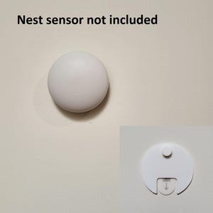 May include: A white round sensor cover with a small white circle in the center. The text "Nest sensor not included" is written above the cover.