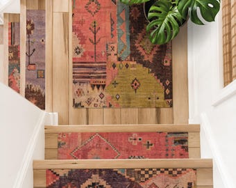 May include: A collection of rectangular area rugs featuring intricate geometric patterns in shades of coral, olive green, dark brown, and muted purple. The rugs are displayed on wooden stair treads and a landing, with a large green monstera plant.