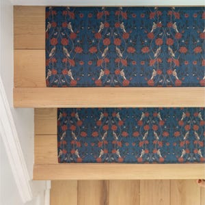 May include: Two patterned stair treads with a blue background and red floral design. The treads are made of a soft, non-slip material and are designed to protect stairs from wear and tear.