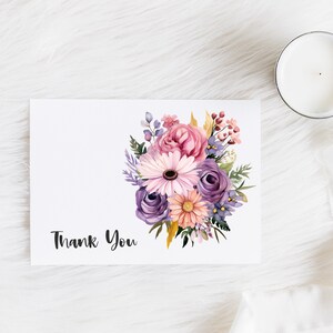 May include: A white card with a watercolor bouquet of pink, purple, and yellow flowers. The text "Thank You" is printed in black at the bottom of the card.