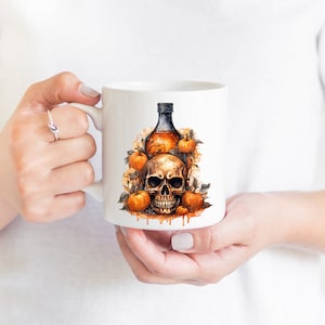 May include: White ceramic mug featuring a Halloween design. The design depicts a skull with a bottle of liquid and pumpkins.