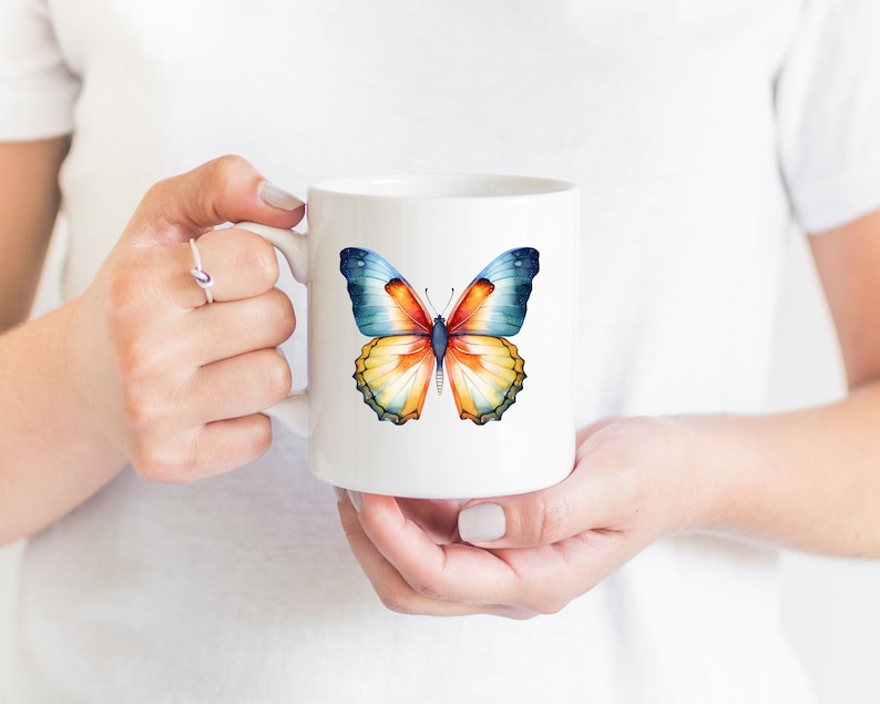 May include: White ceramic mug with a colorful butterfly design. The butterfly has blue, orange, and yellow wings.