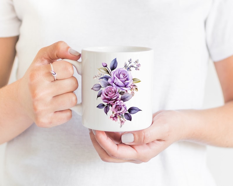 May include: White ceramic mug with a purple floral design. The flowers are watercolor style and include roses and leaves.