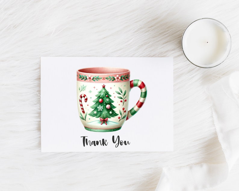 May include: A greeting card with a watercolor illustration of a Christmas-themed mug. The mug features a Christmas tree, candy cane, and floral details. The handle is striped red and green. The words "Thank You" are written below the mug.