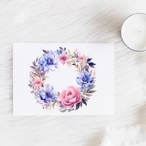 May include: A watercolor wreath with pink and blue flowers and green leaves. The wreath is on a white background.