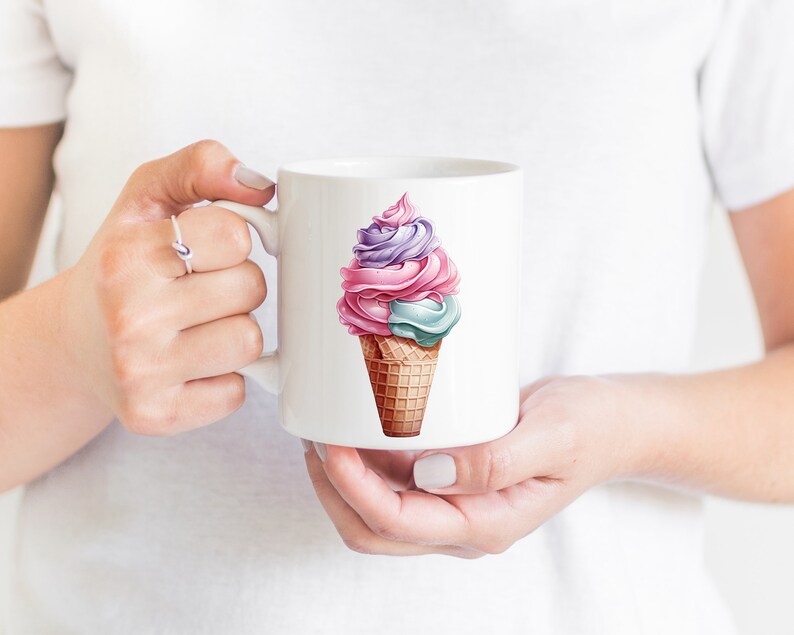 May include: White ceramic mug featuring a colourful ice cream cone design. The ice cream is pink, purple and blue with a waffle cone.