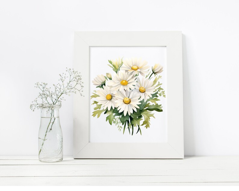 May include: A white framed print featuring a watercolour painting of a bouquet of white daisies with yellow centres. The daisies are arranged in a cluster with green leaves.