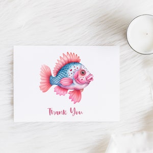 May include: A white card with a pink and blue fish illustration and the text "Thank You".