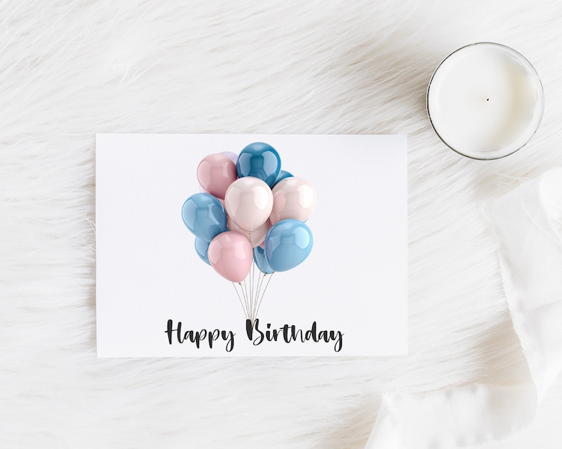 May include: A white greeting card with the text "Happy Birthday" in black script. The card features a cluster of pastel-colored balloons in shades of pink, blue, and teal. A white candle sits to the right.